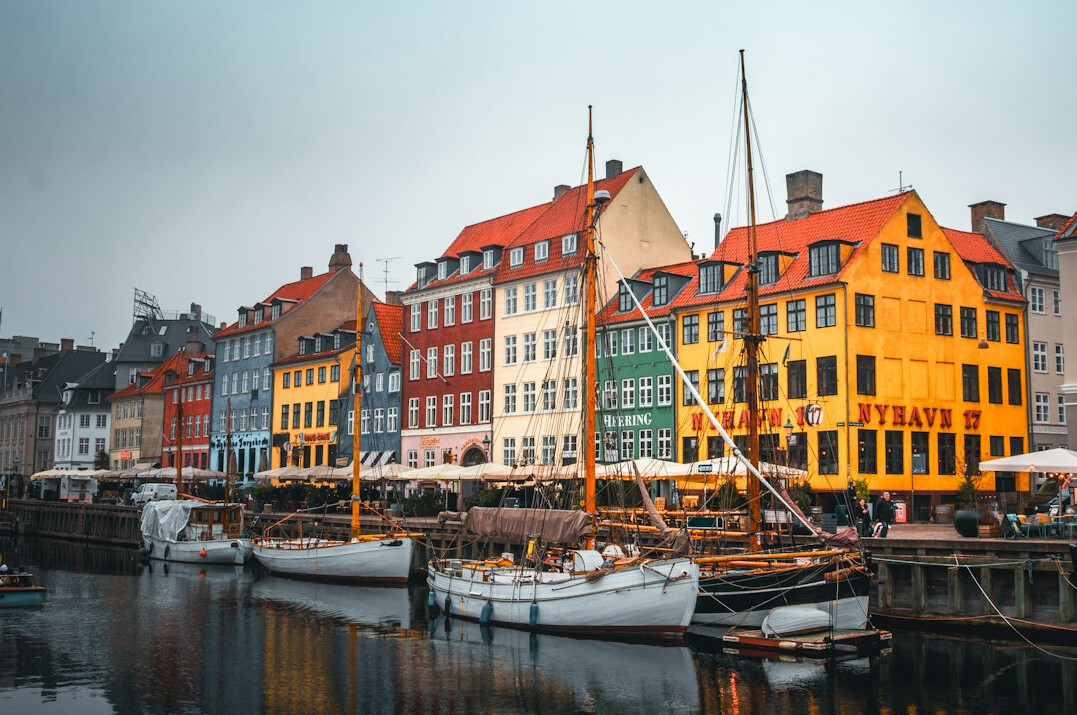 Colorful harbor houses along a Danish canal at dusk