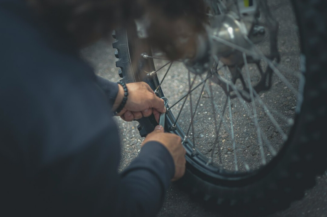 man repairing bicycle